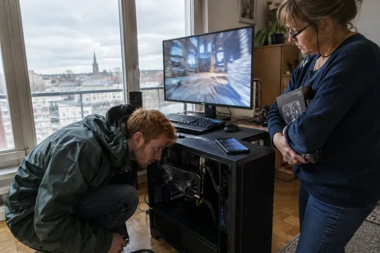 Chez une vendeuse à Caen, un acheteur tend l’oreille vers les ventilateurs d’une carte graphique d’occasion pendant un test en charge